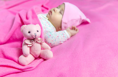 Close-up of teddy bear on bed at home