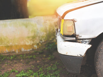 Close-up of yellow car on road