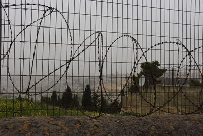 Barbed wire fence against sky