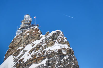 Low angle view of mountain against sky during winter