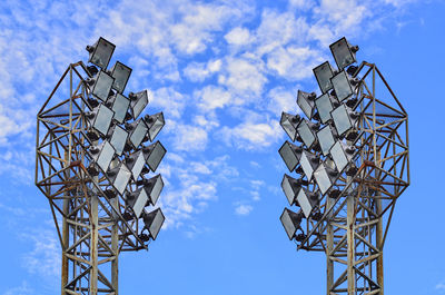 Low angle view of floodlights against sky