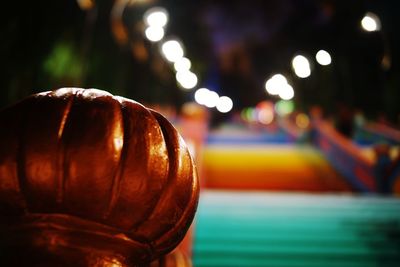 Close-up of illuminated ball on metal at night