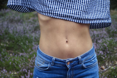 Midsection of woman standing on field