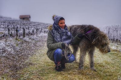 Portrait of young woman with horse in winter