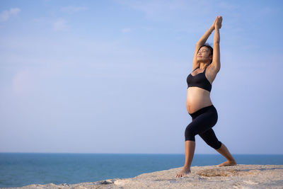 Full length of woman on beach against sky