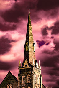 Low angle view of church against cloudy sky