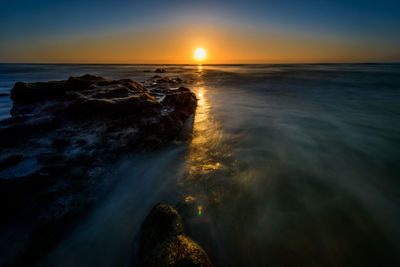 Scenic view of sea against sky during sunset