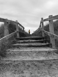 Low angle view of man on staircase against sky