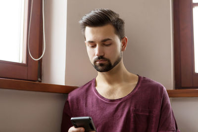 Man using mobile phone at home