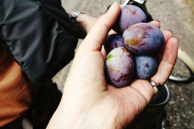 Cropped image of hands holding grapes