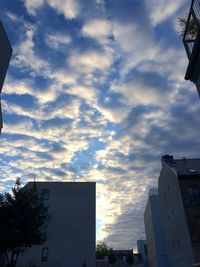 Low angle view of building against cloudy sky