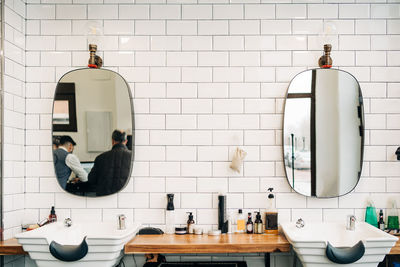 Rear view of man and woman standing in bathroom