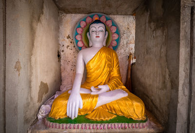 Statue of buddha against building