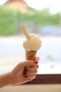 Hand holding ice cream cone