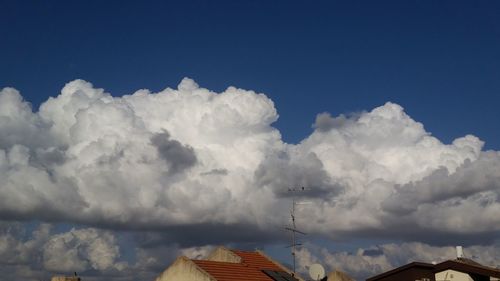 Low angle view of clouds over mountains