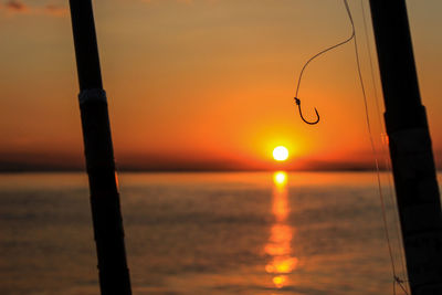 Scenic view of sea against orange sky