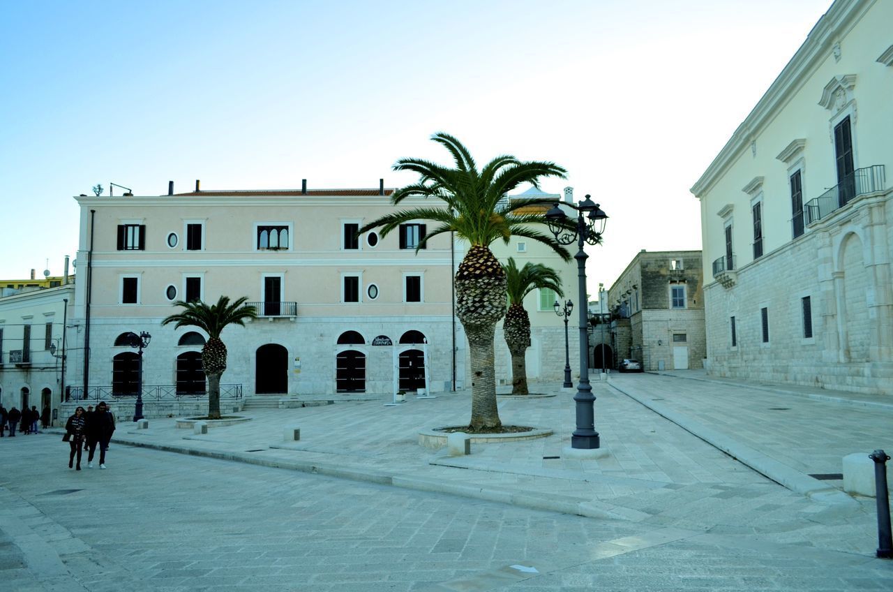 STREET AMIDST BUILDINGS AGAINST SKY