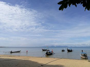 People on beach against sky