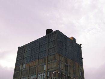 Low angle view of building against cloudy sky