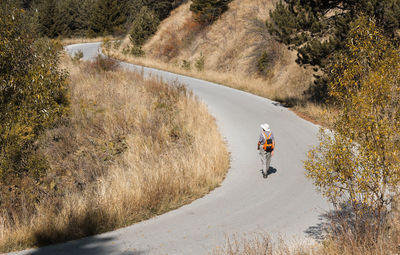 Rear view of woman walking on landscape