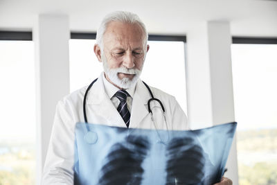 Senior doctor examining medical x-ray in hospital