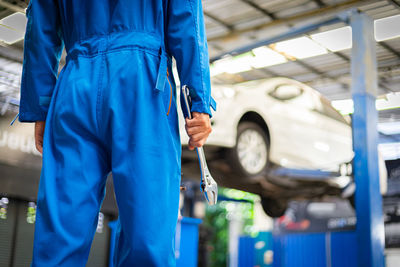 Man working on blue car