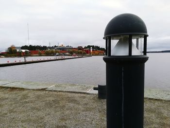 Built structure by lake against sky