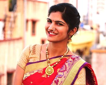 Portrait of smiling young woman wearing sari outdoors