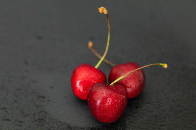 Close-up of strawberries on table against black background