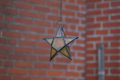 Close-up of crane against wall