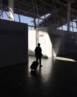 Full length of woman standing on railing