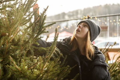 Woman choosing christmas tree