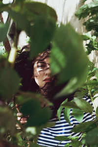 Young man with plants in foreground