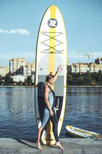 Full length of woman standing in city against sky