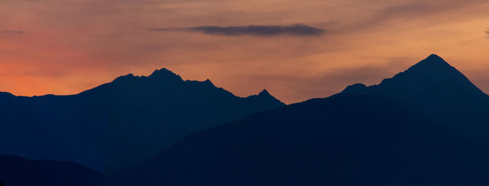 Scenic view of silhouette mountains against sky during sunset