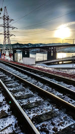 Railroad tracks against sky during winter