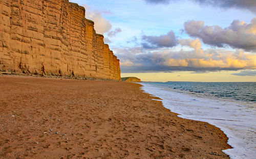 View of beach against cloudy sky