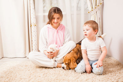 Two women sitting in corridor