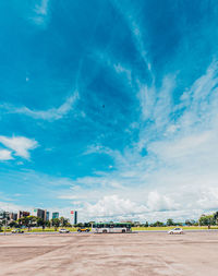 People at beach against sky