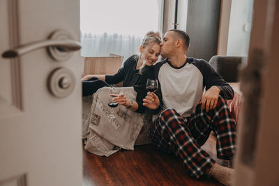 Man and woman sitting at window