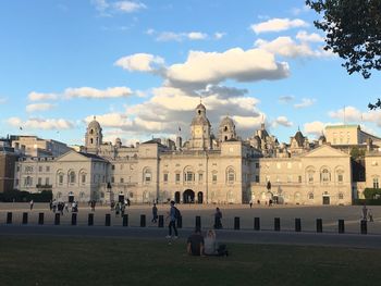 Tourists at town square against sky