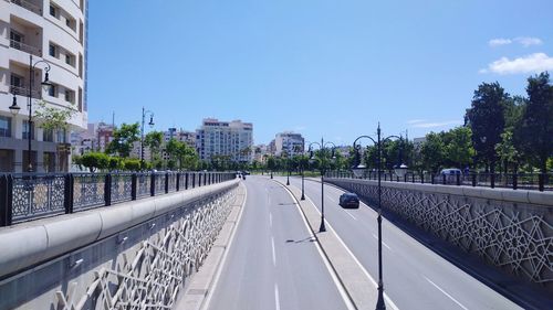 Road by city against sky