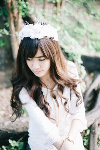 Woman wearing tiara in forest