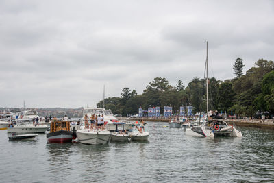 Boats sailing in river against sky