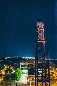 Illuminated building against sky at night