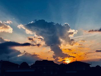 Low angle view of silhouette buildings against sky during sunset