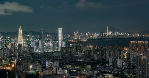 Illuminated cityscape against sky at night