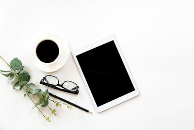 High angle view of coffee cup over white background