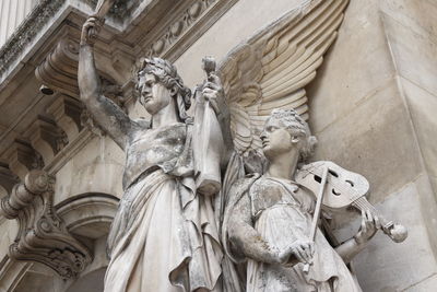 Side view sculptural group of instrumental music that decorate the facade of the opera garnier