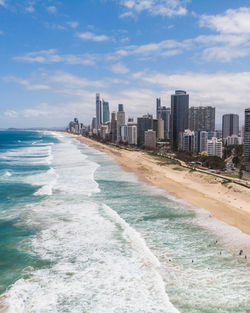 Panoramic view of beach and buildings against sky